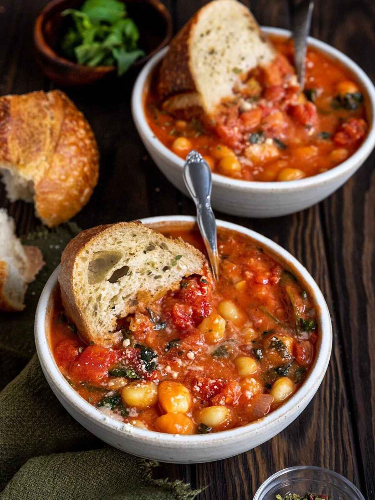 Tomato Gnocchi Soup served in two white bowls with bread