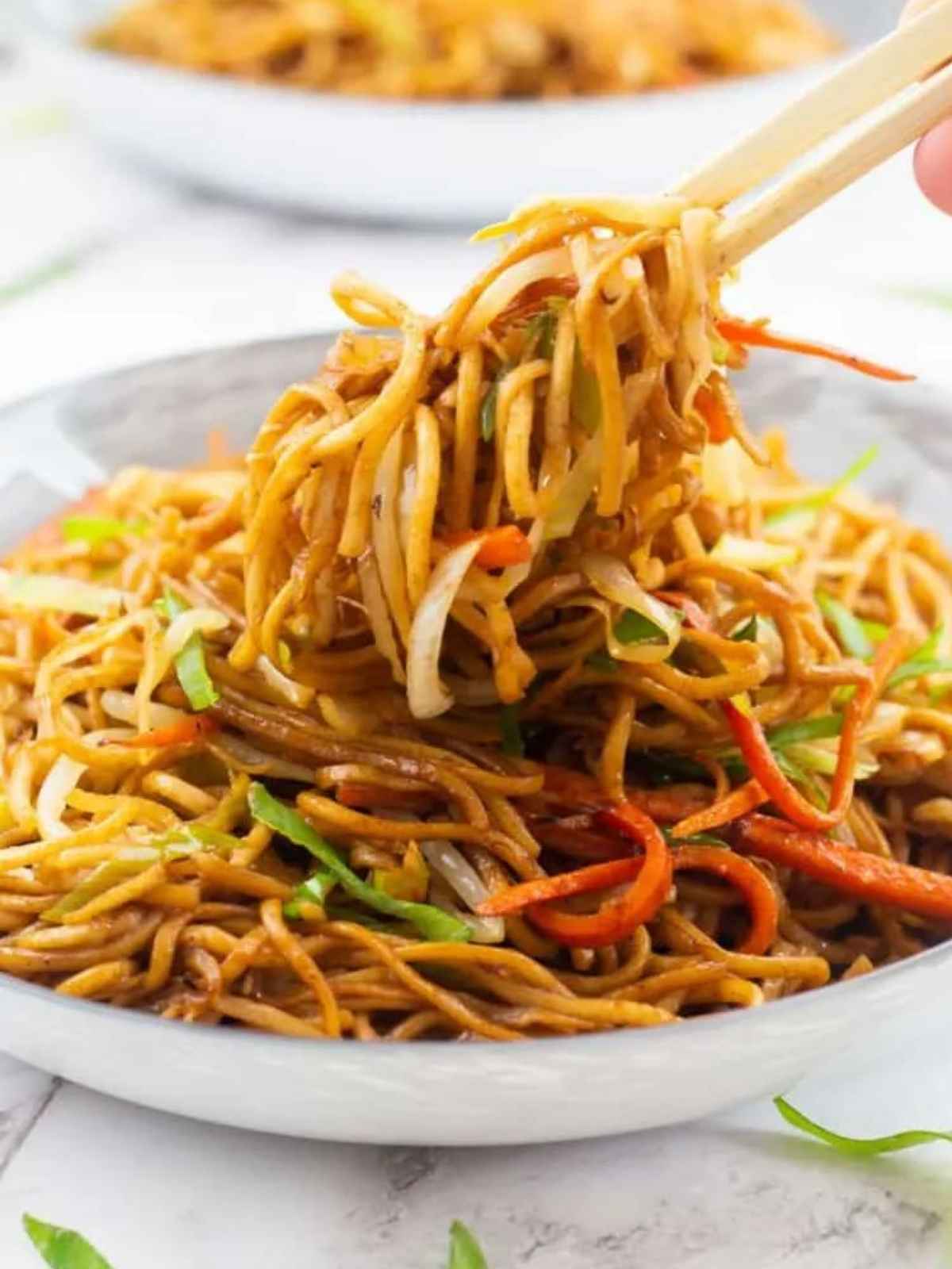 Vegetable chow Mein on a chop stick.