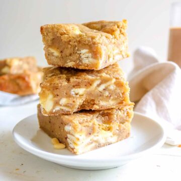 eggless blondies stacked on a white plate