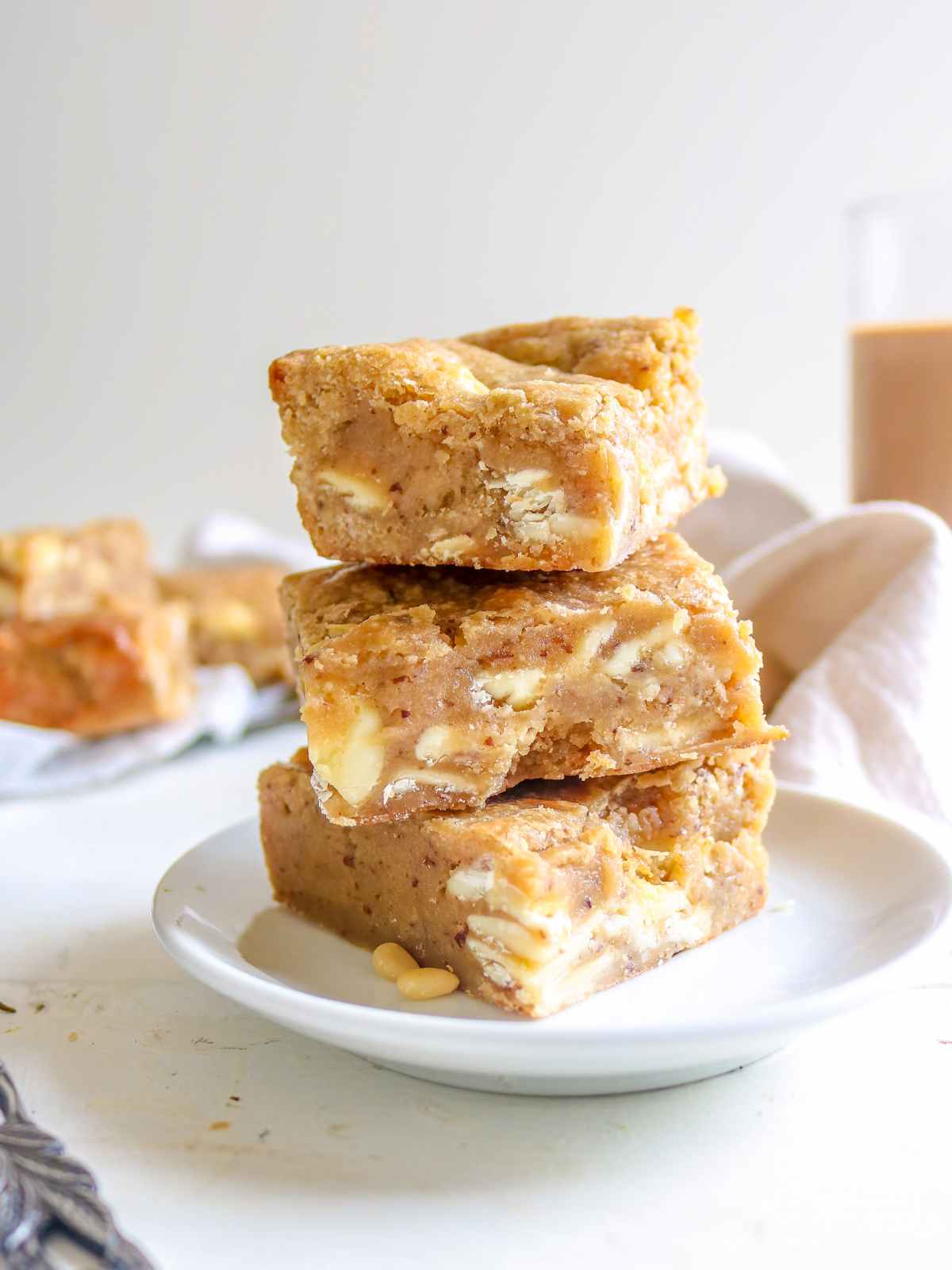 Three blondies stacked in a white plate.