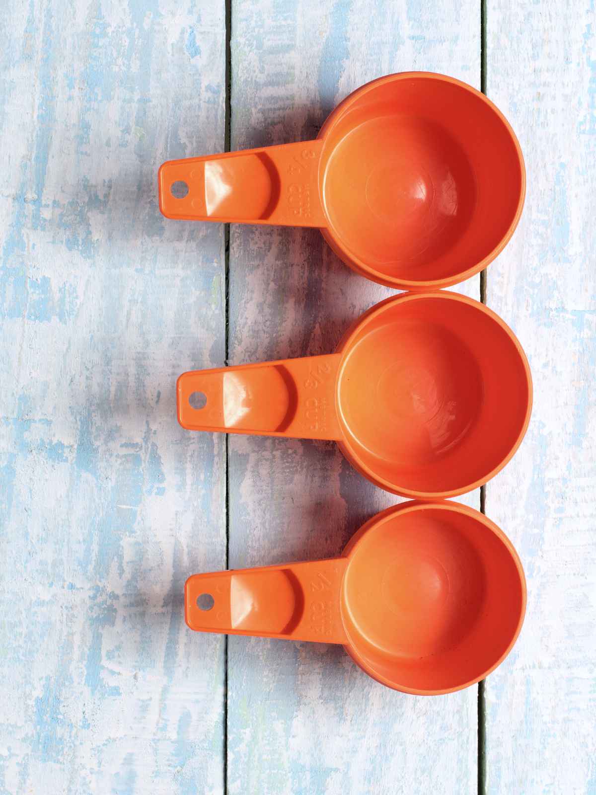 orange color measuring cups on a blue background.