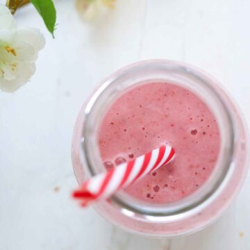 Top view of pink color smoothie in a glass jar.