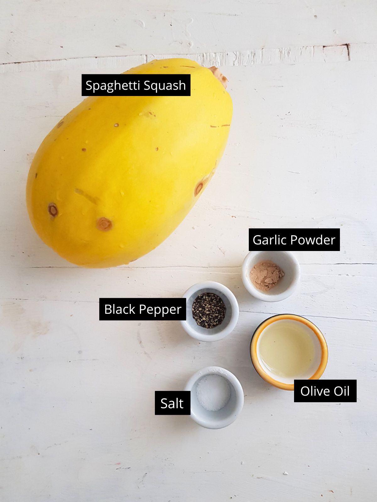 ingredients to make spaghetti squash in air fryer placed on a white background.