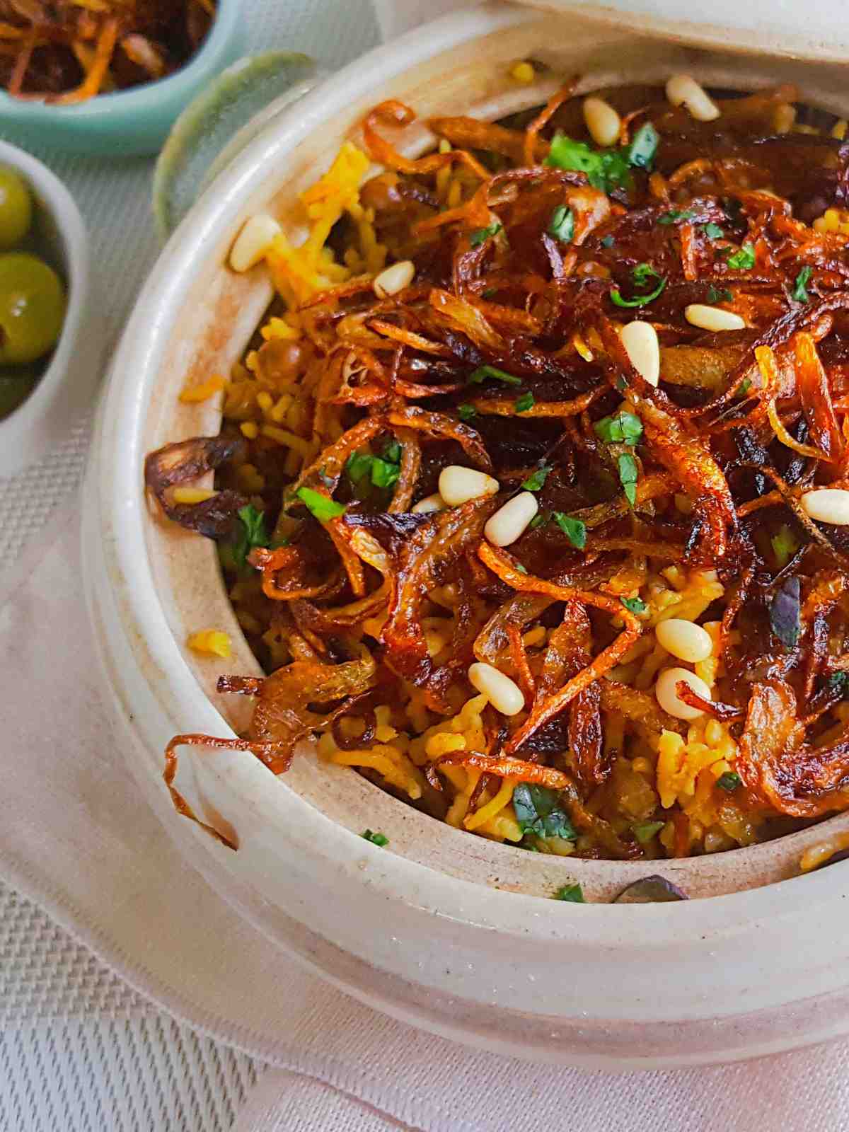 lentil and rice served in a bowl topped with caramelized onions.