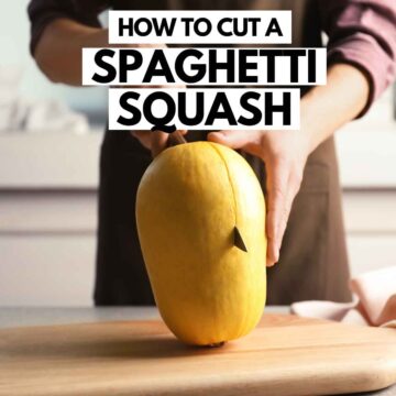 Cutting a spaghetti squash with chef knife.