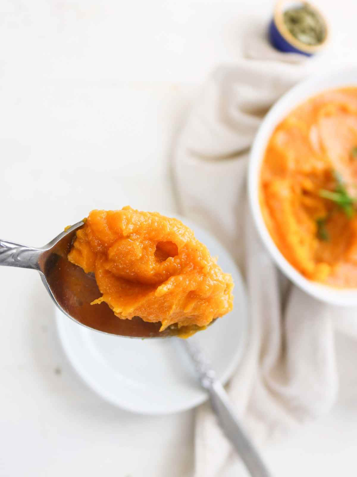 Butternut squash mash in a spoon.