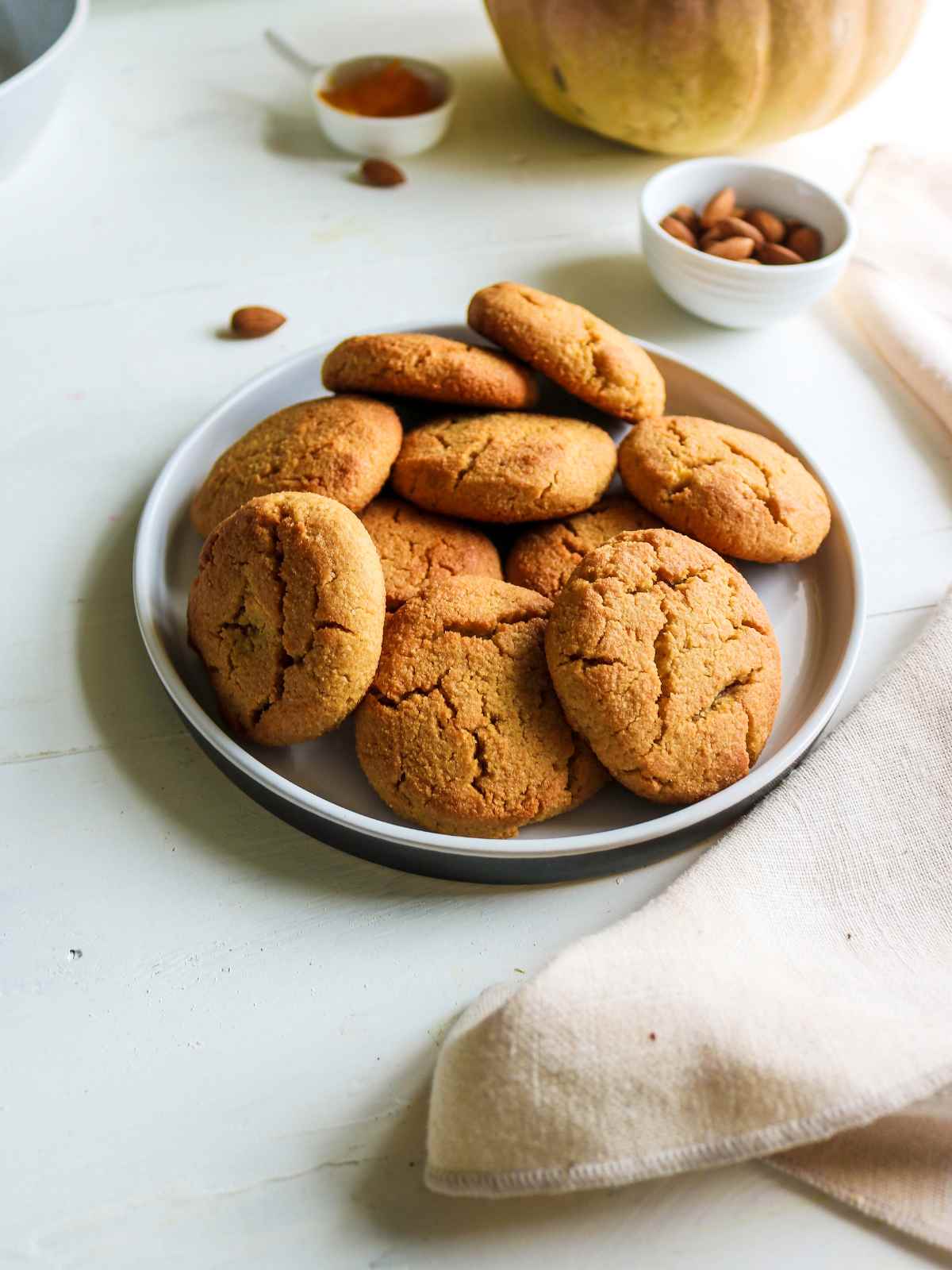 Pumpkin Almond Flour Cookies stacked in a plate.