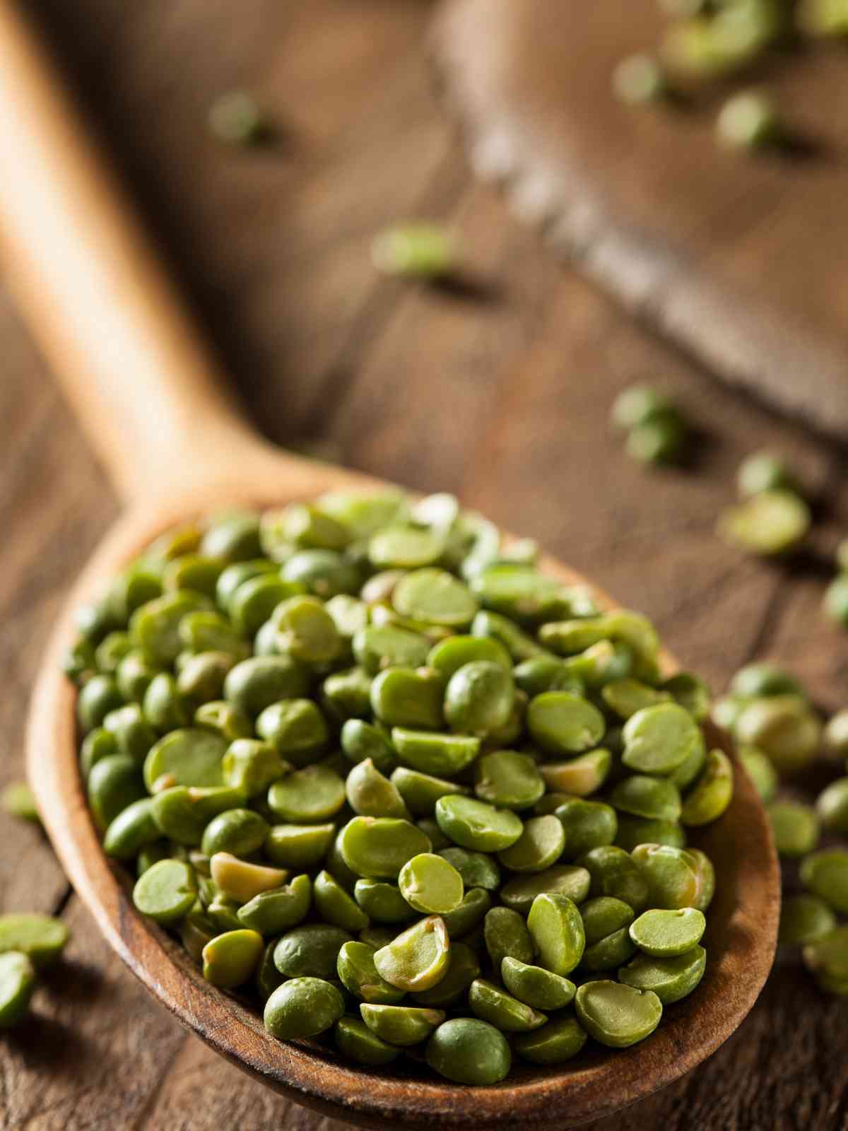 Split peas Lentils placed on wooden spoon. 