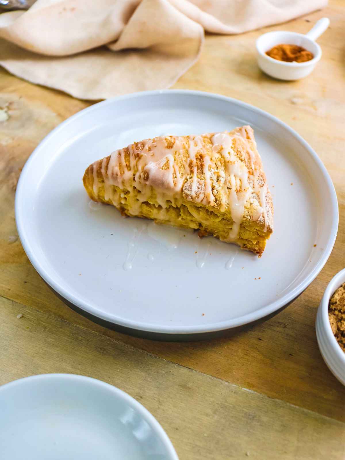 Eggless pumpkin scone served in a white plate.