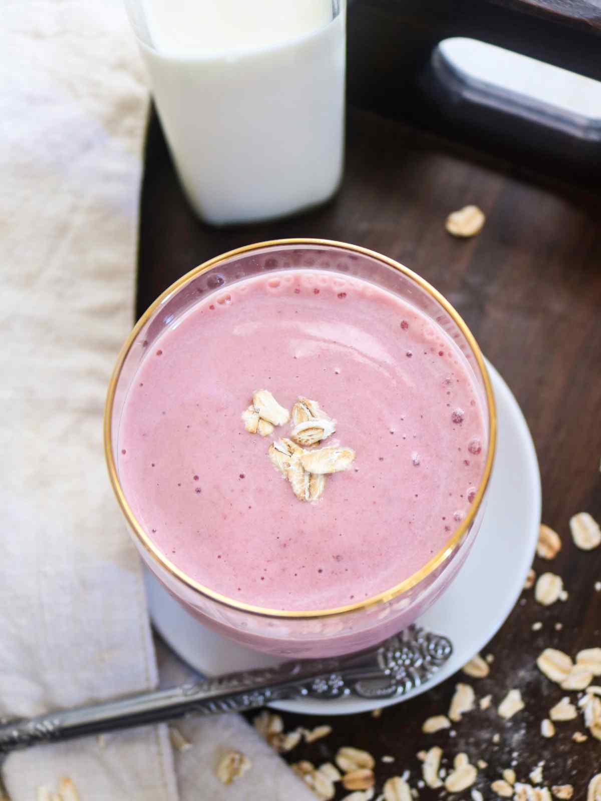 smoothie in a glass jar placed on a white plate.