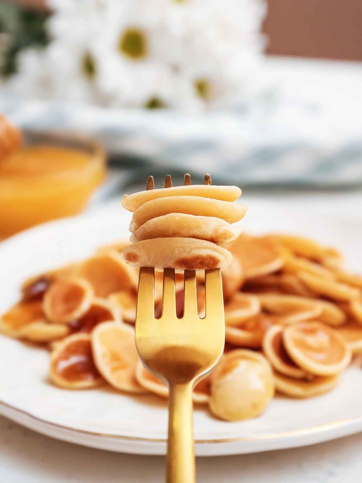 Mini pancakes on fork.