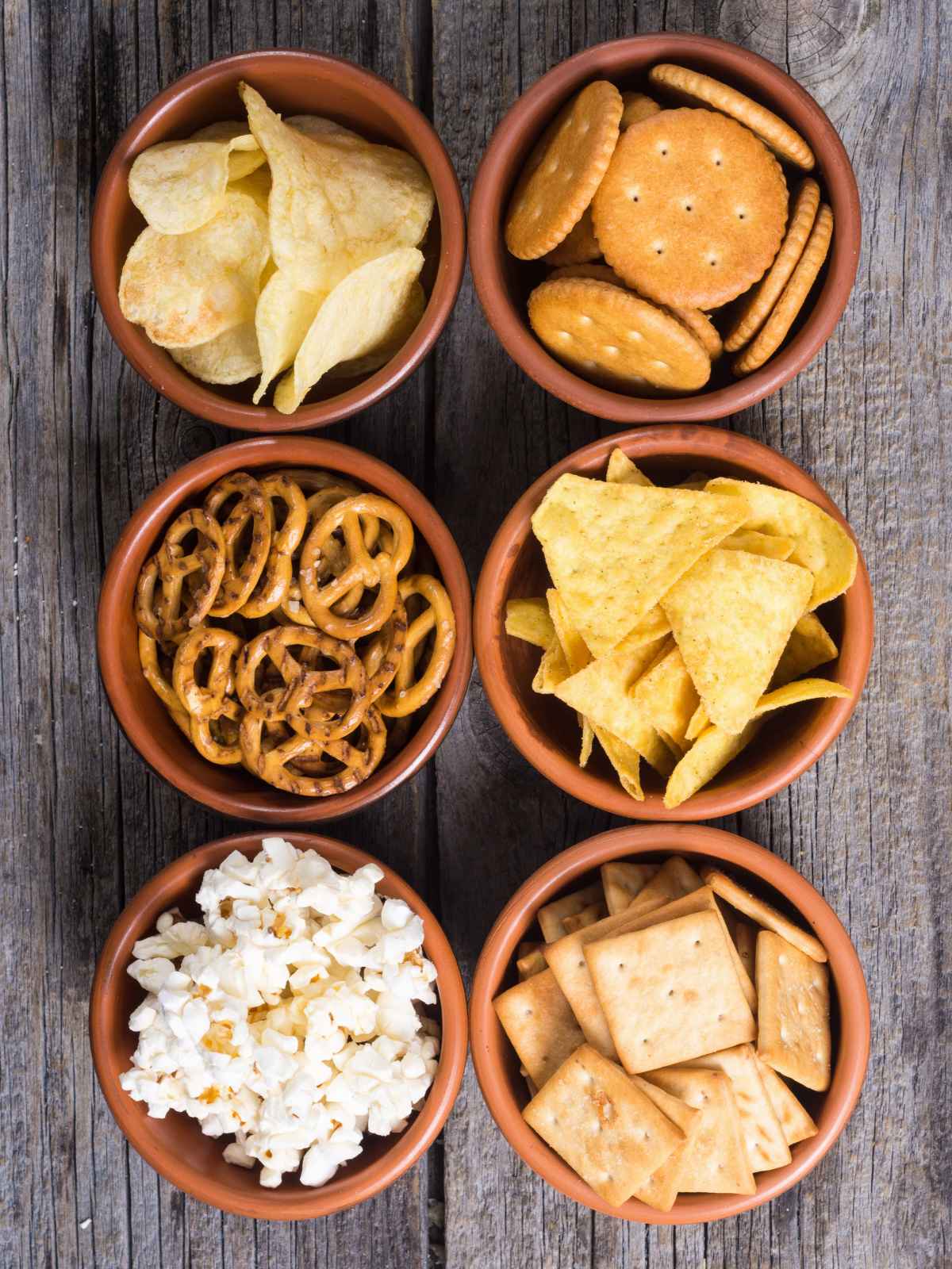 Savory snacks as dippers placed in separate bowls.