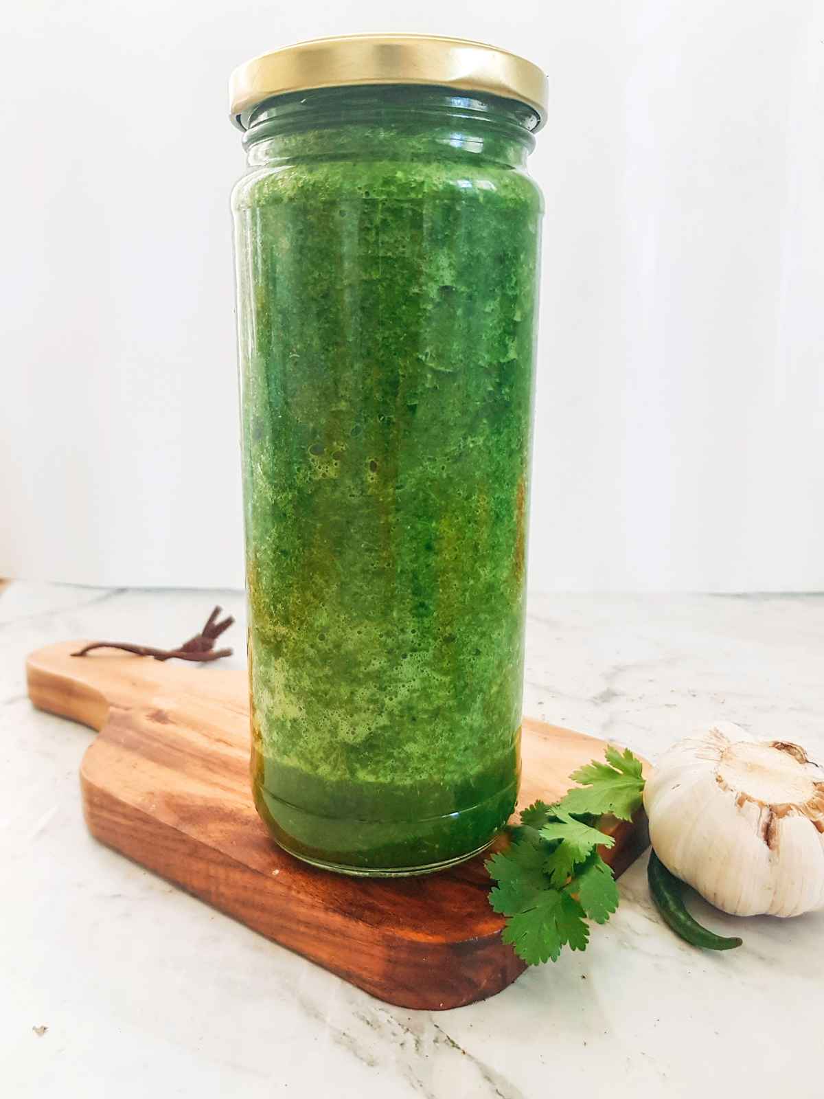 Coriander chutney stored in an air tight bottle.