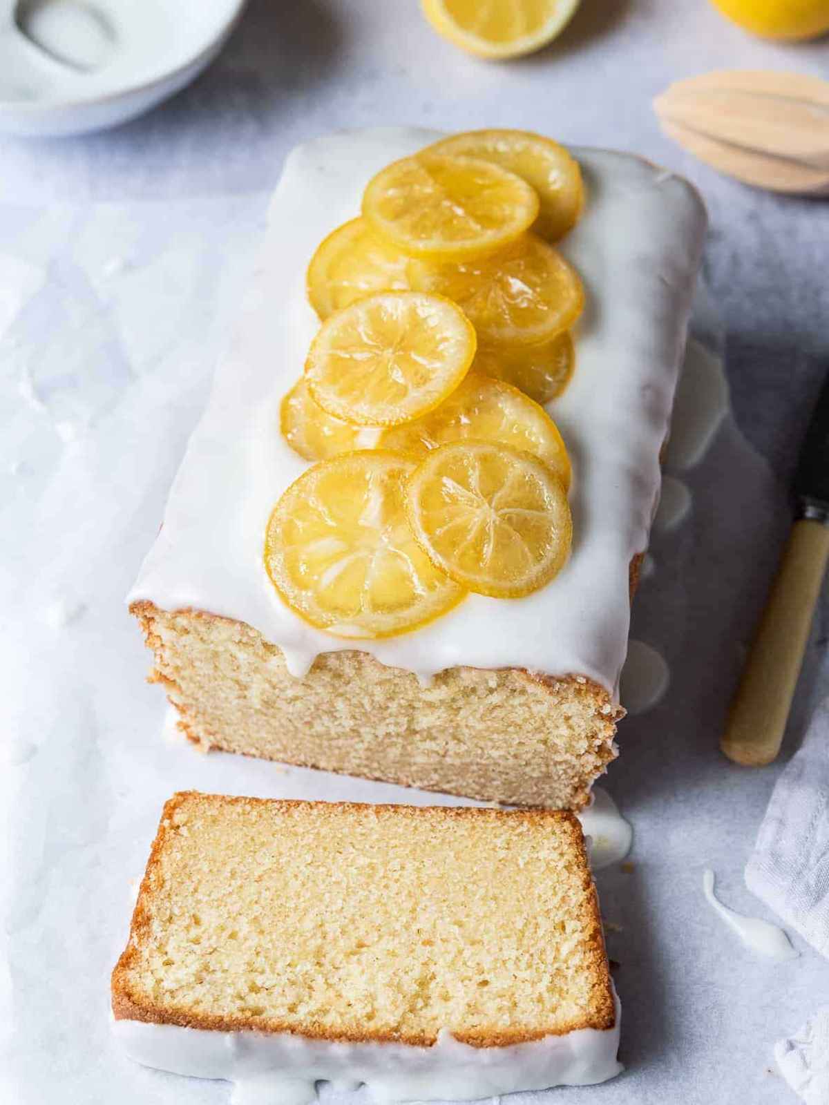 Pound cake garnished with white icing and candied lemon slices.