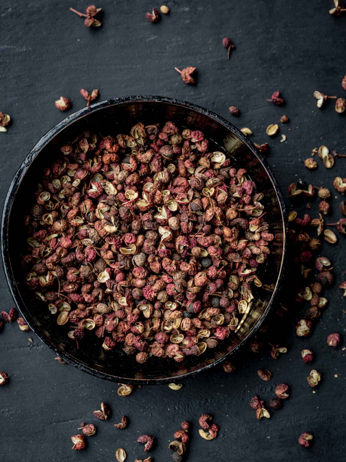 Sichuan Peppercorns in a black plate.