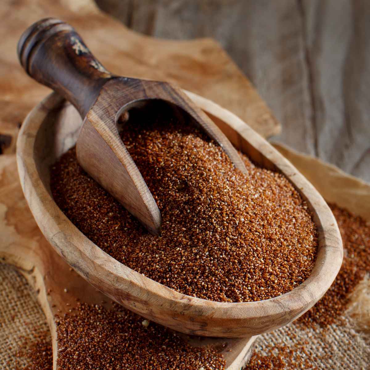 Teff grains placed in a wooden bowl.