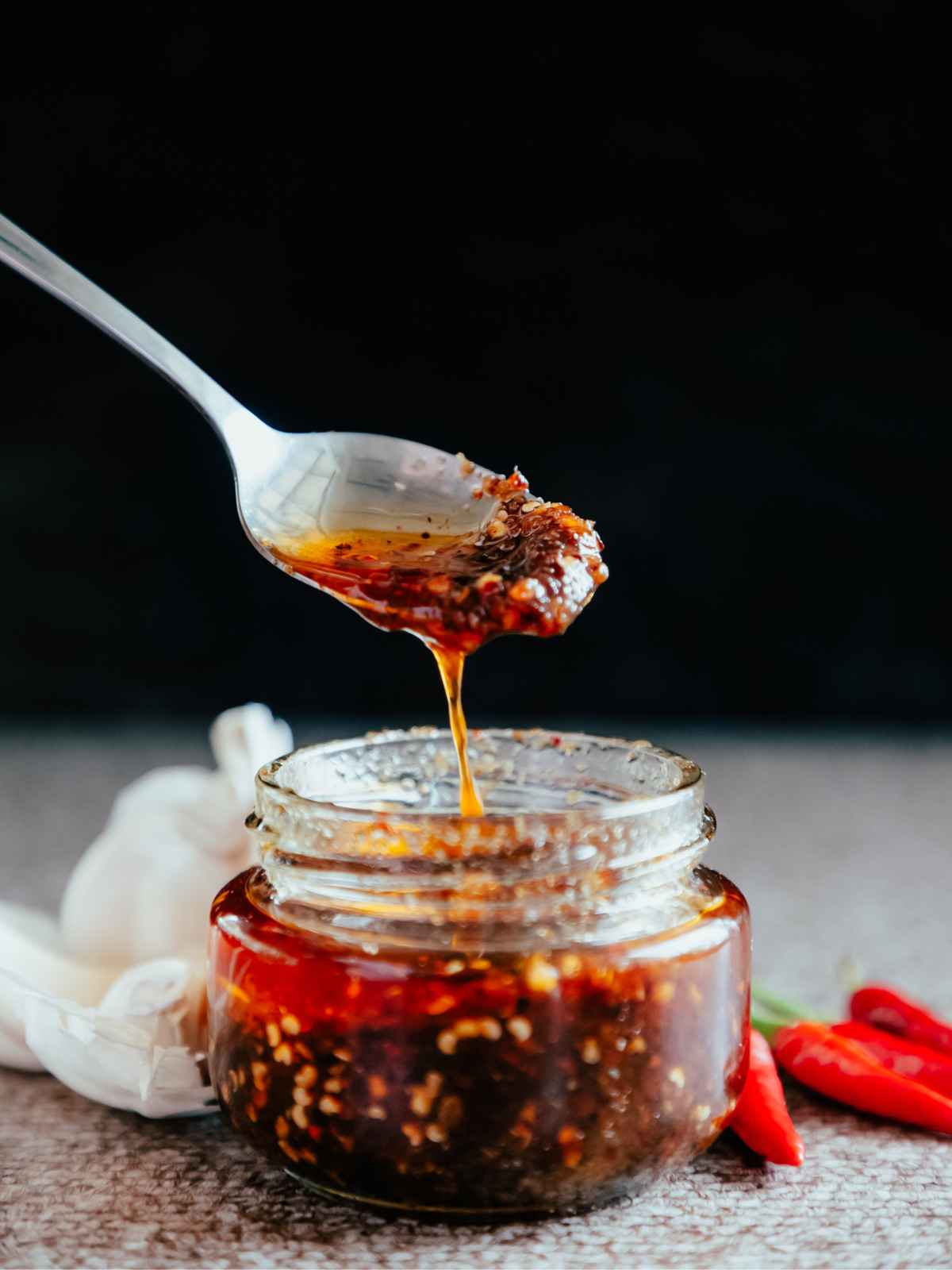 Pouring chili oil with a spoon.