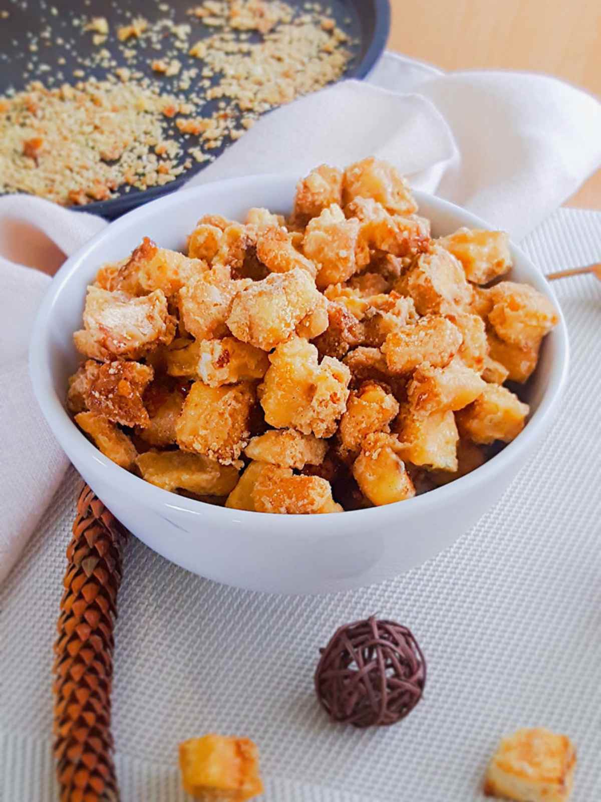 Crispy bread croutons served in a white bowl.