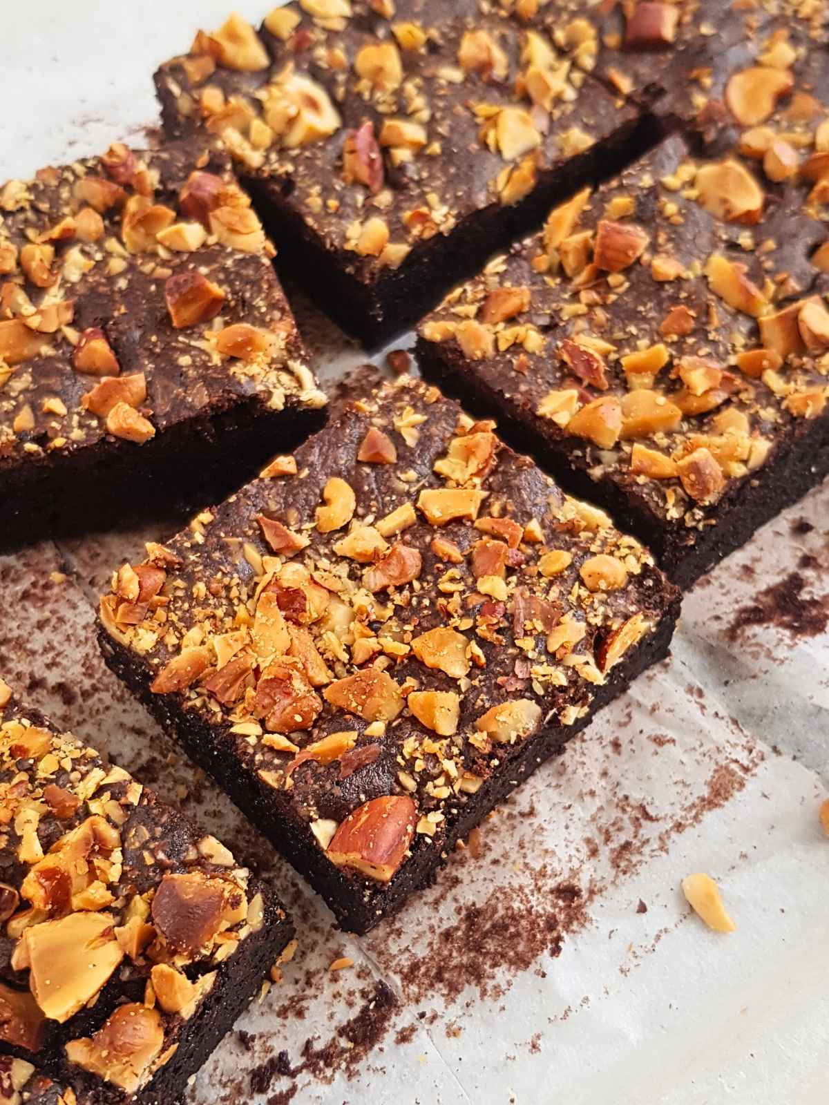 Chickpea brownies slice with nuts on top.