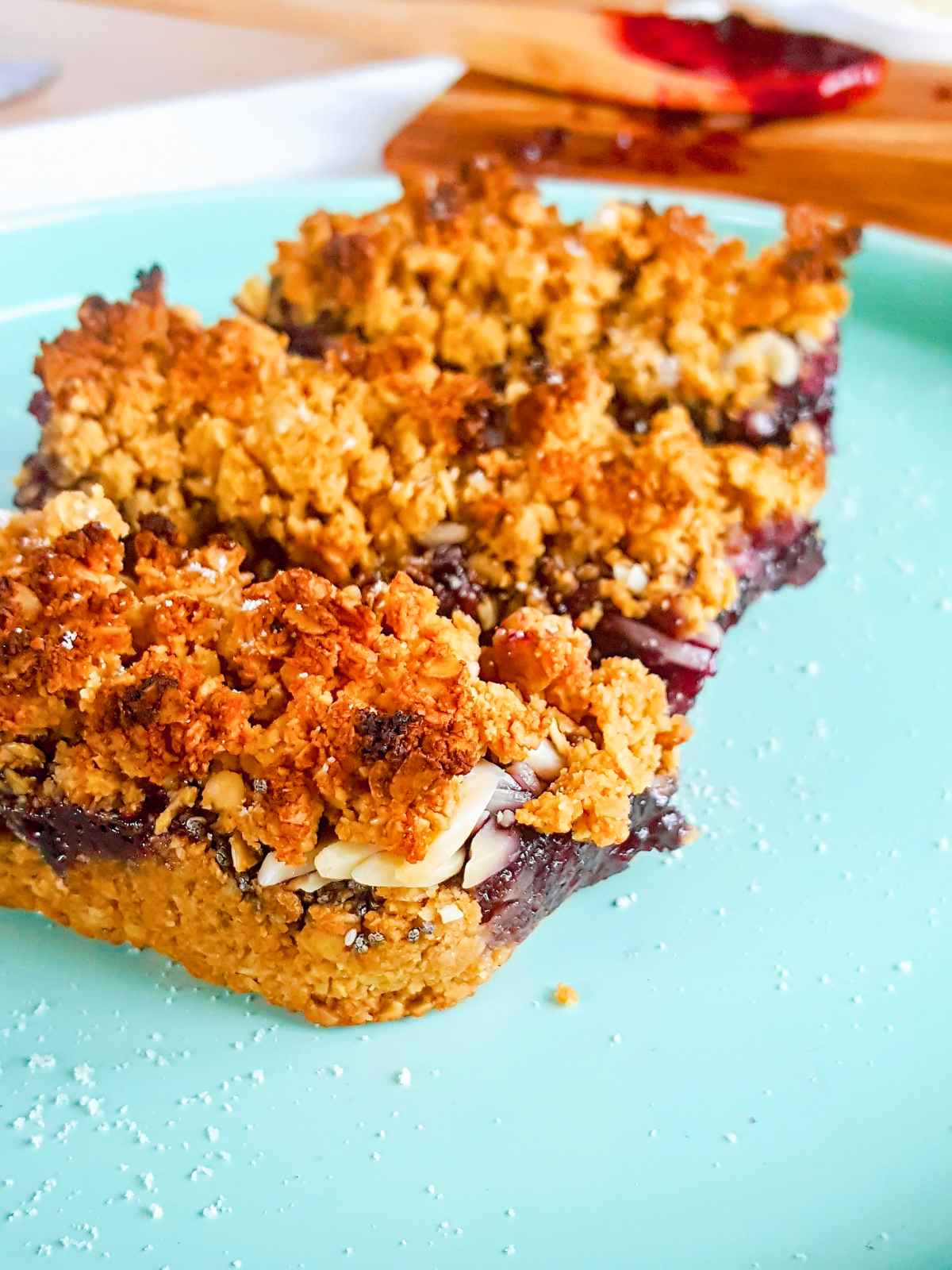 Jam crumb top slices served on a plate.