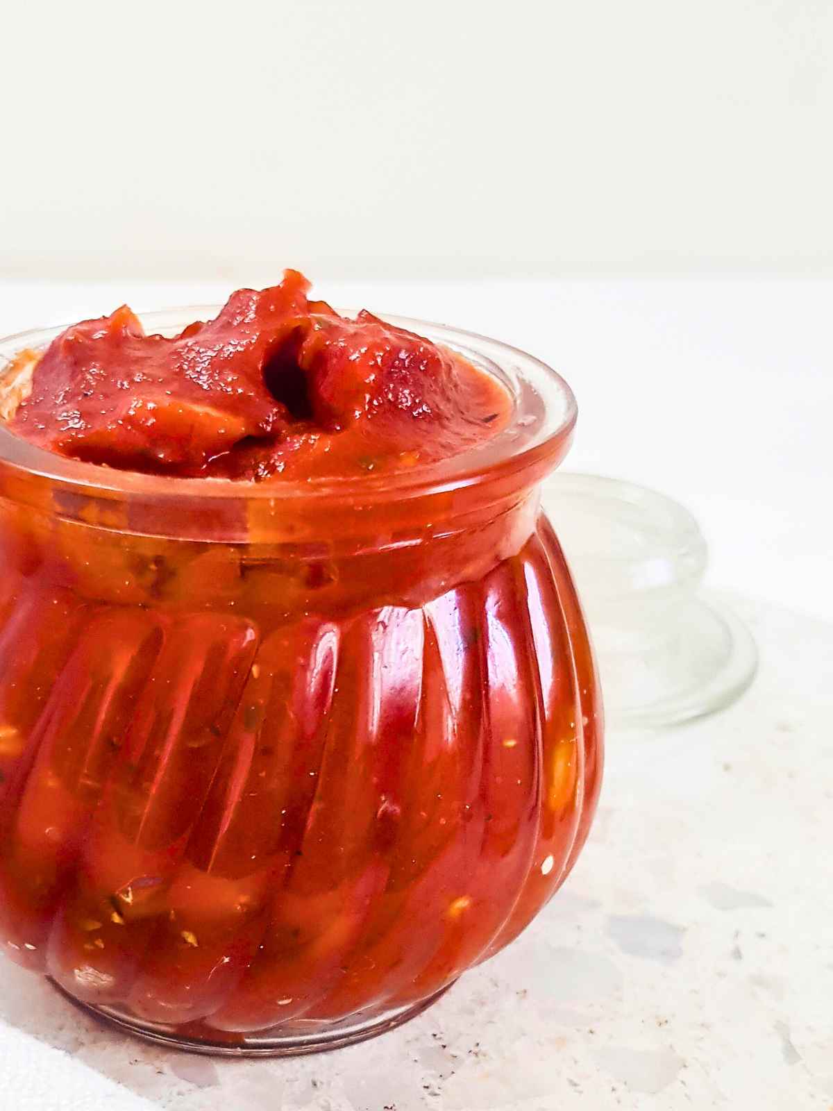 Pizza sauce in glass jar.
