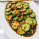 Din Tai Fung Cucumber placed in a white dish.