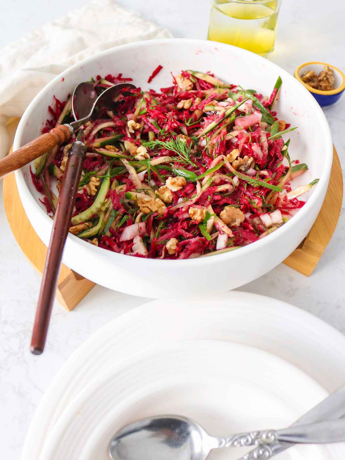 Garnish the Cucumber Beetroot Salad  with walnuts and dill.