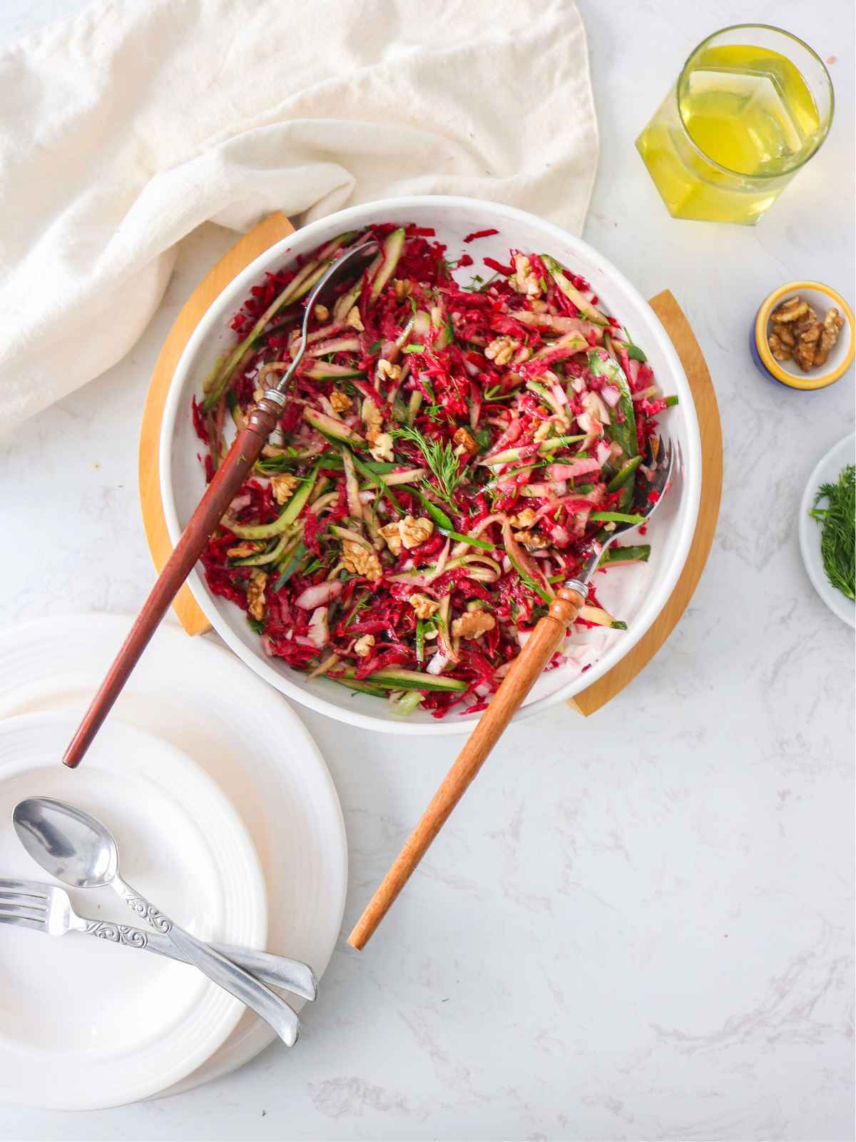 Top view of cucumber beet salad served in a white dish.