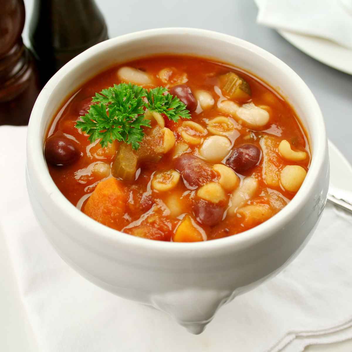 Minestrone soup in a white bowl.