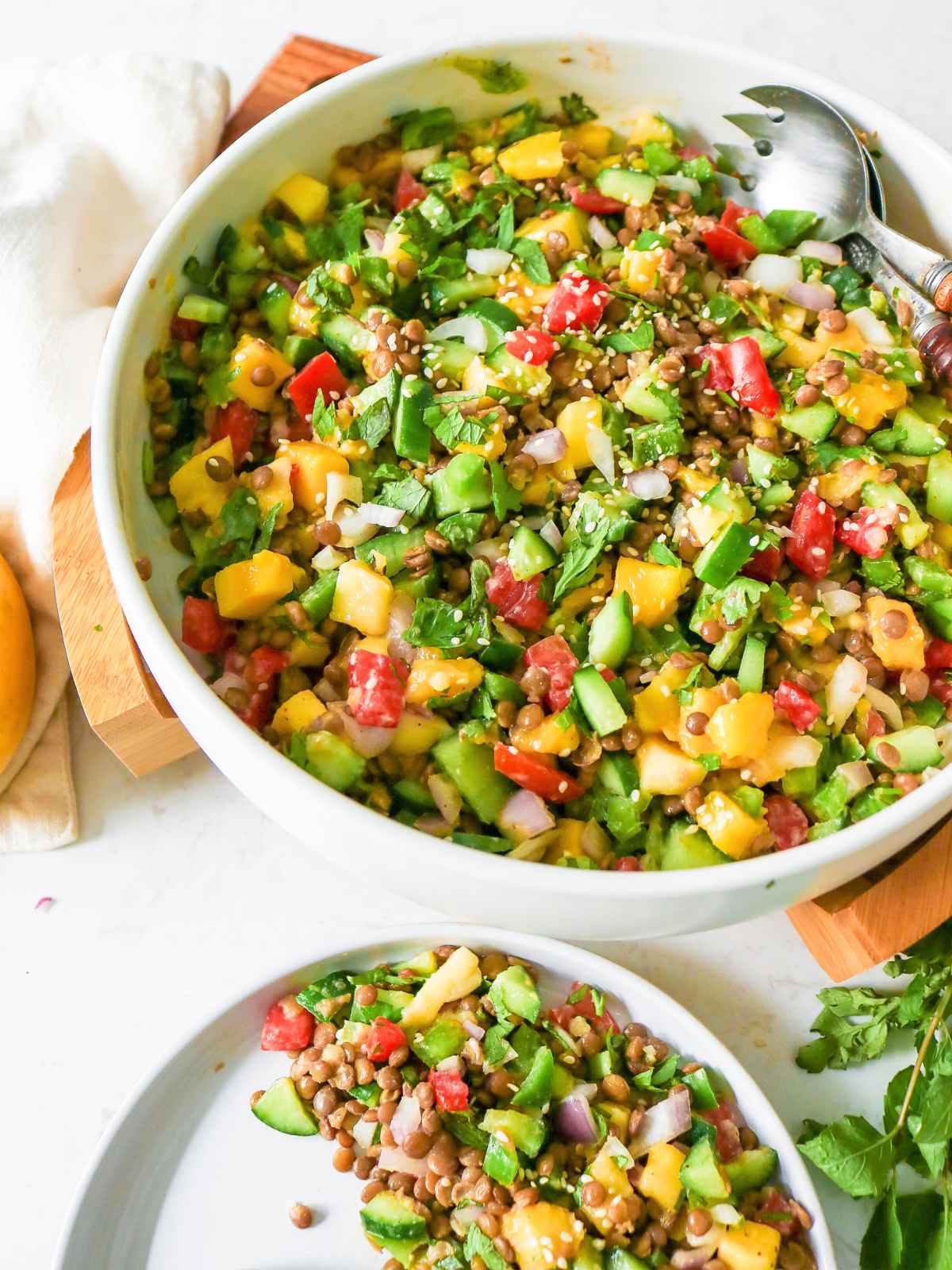 Mango Cucumber Salad served in a bowl topped with sesame seeds.