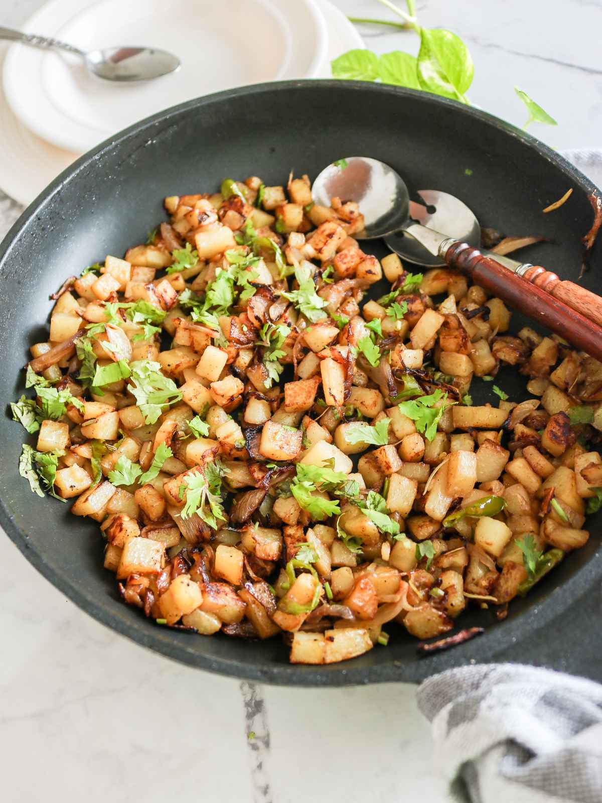 Onions and Potatoes Skillet and spoons on side.