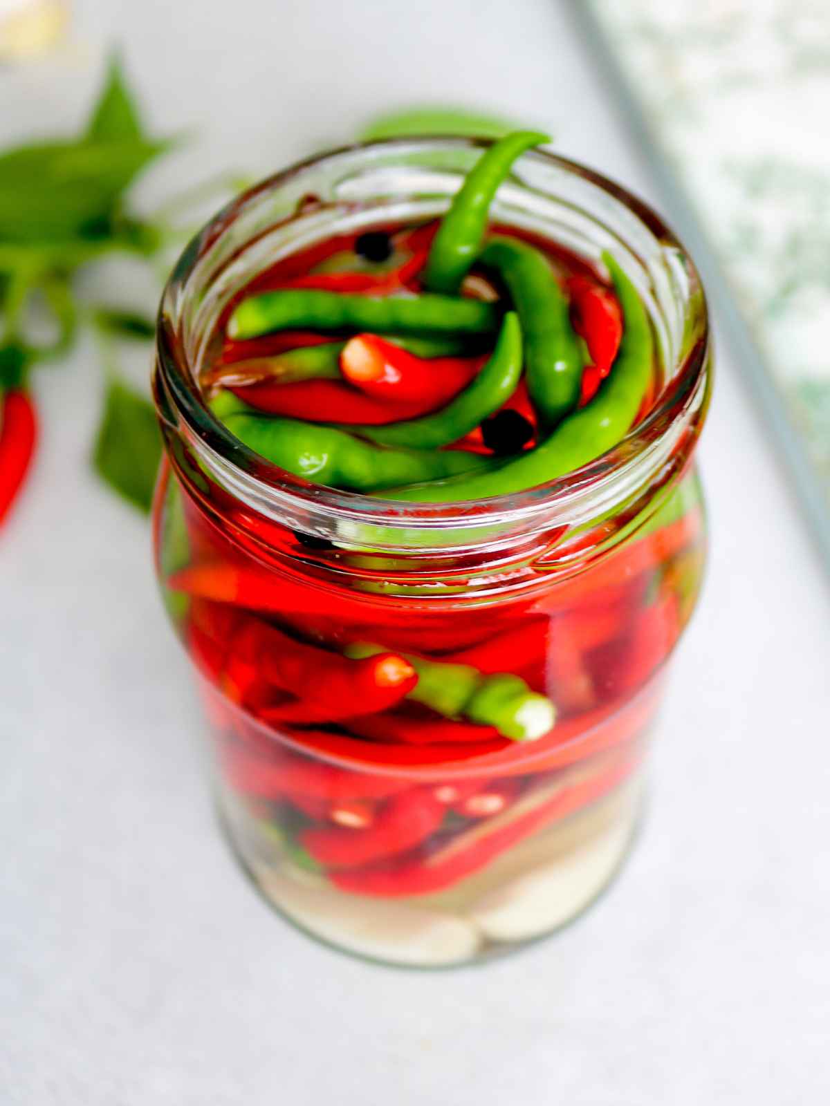 Pickled chillies in a glass jar.