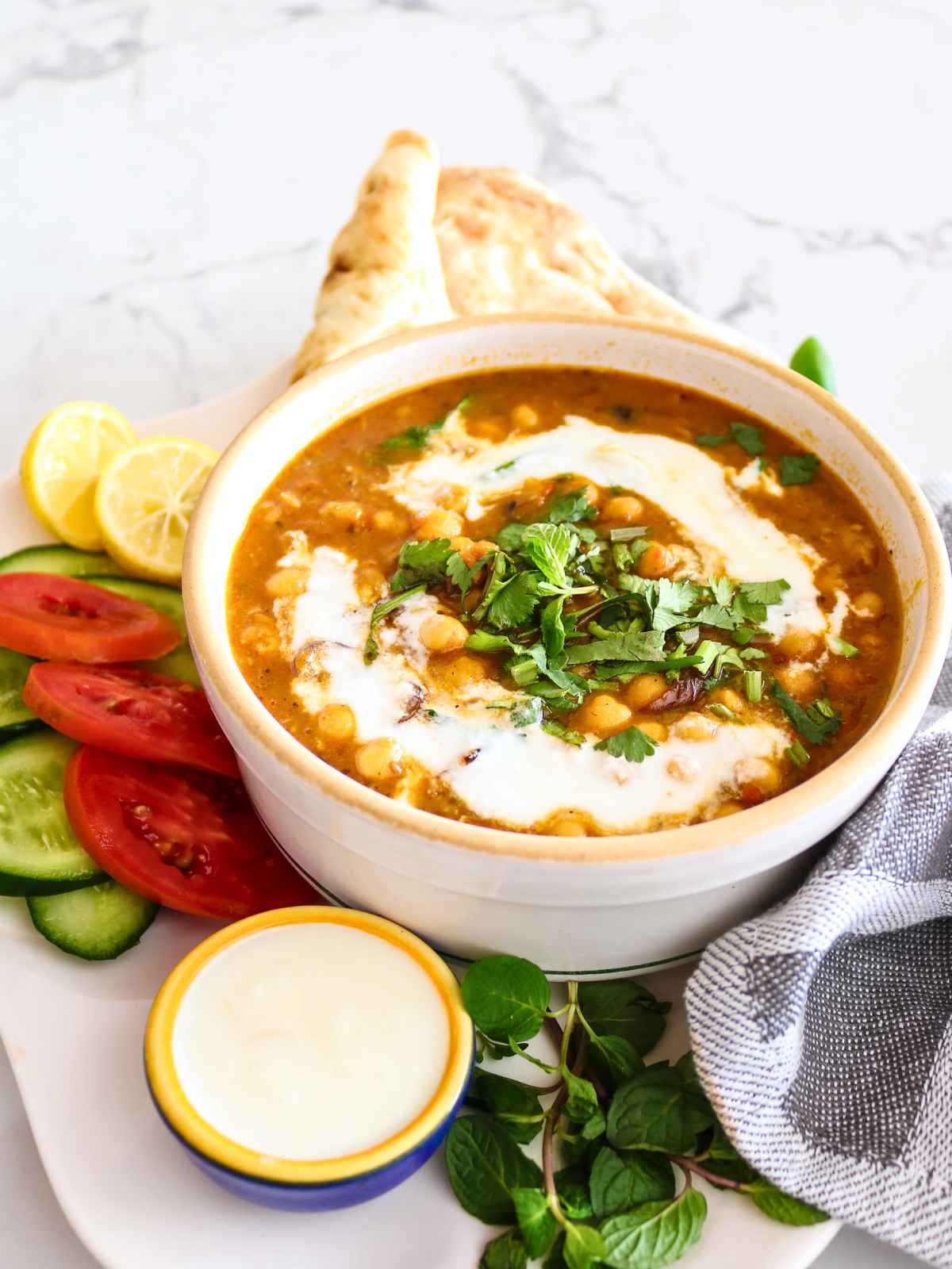 Chickpeas curry served with naan and salad.