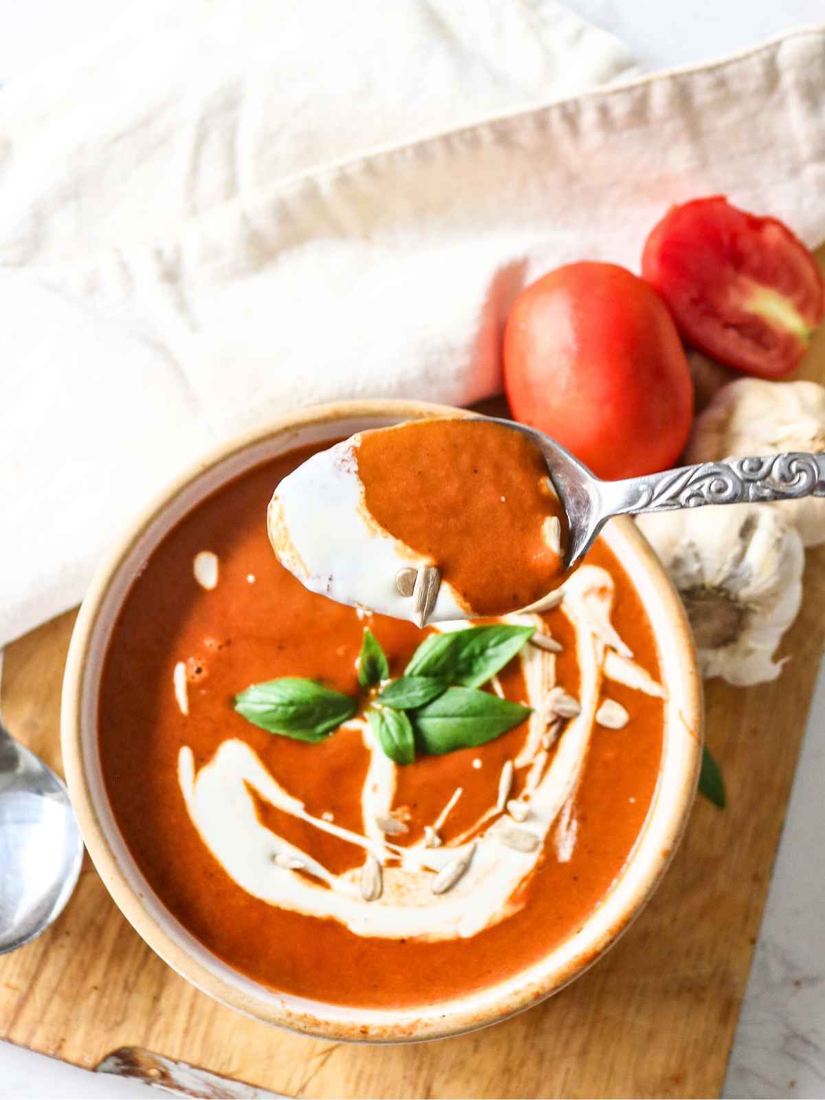 Soup served in a bowl and spoon filled with soup.