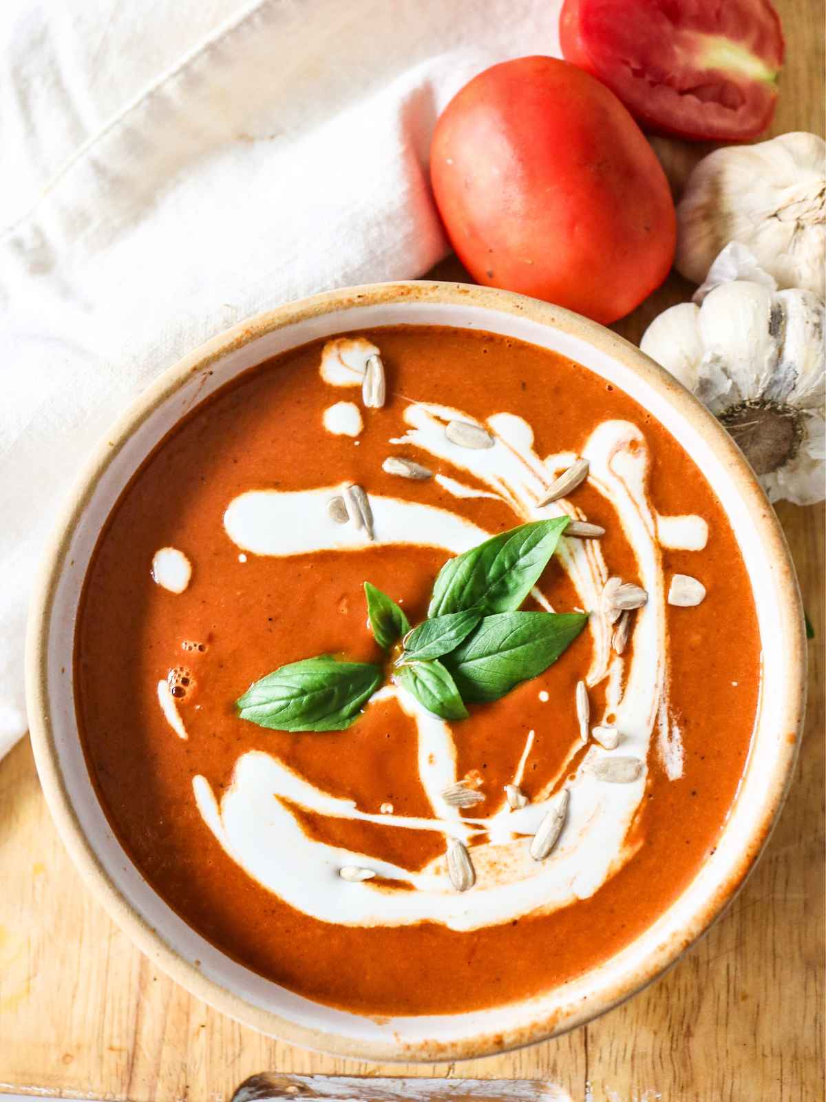 Roasted garlic and tomato soup served in a bowl.