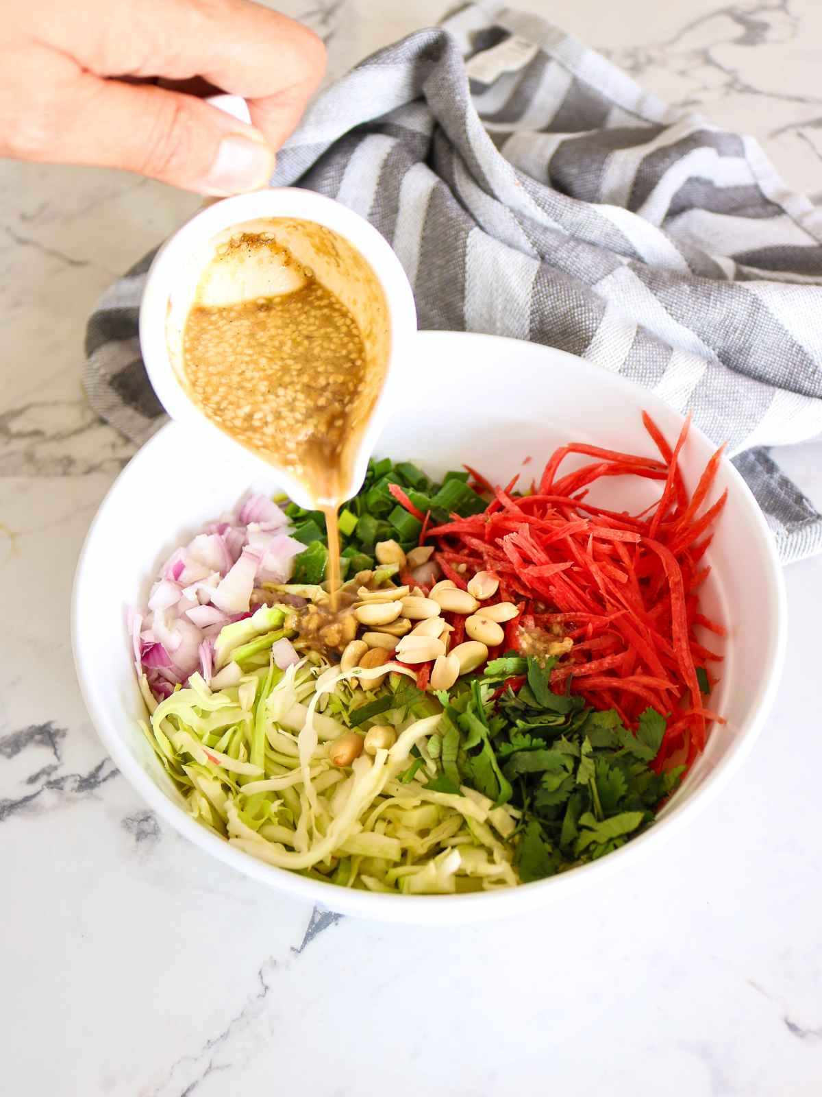 Pouring Dressing over salad.