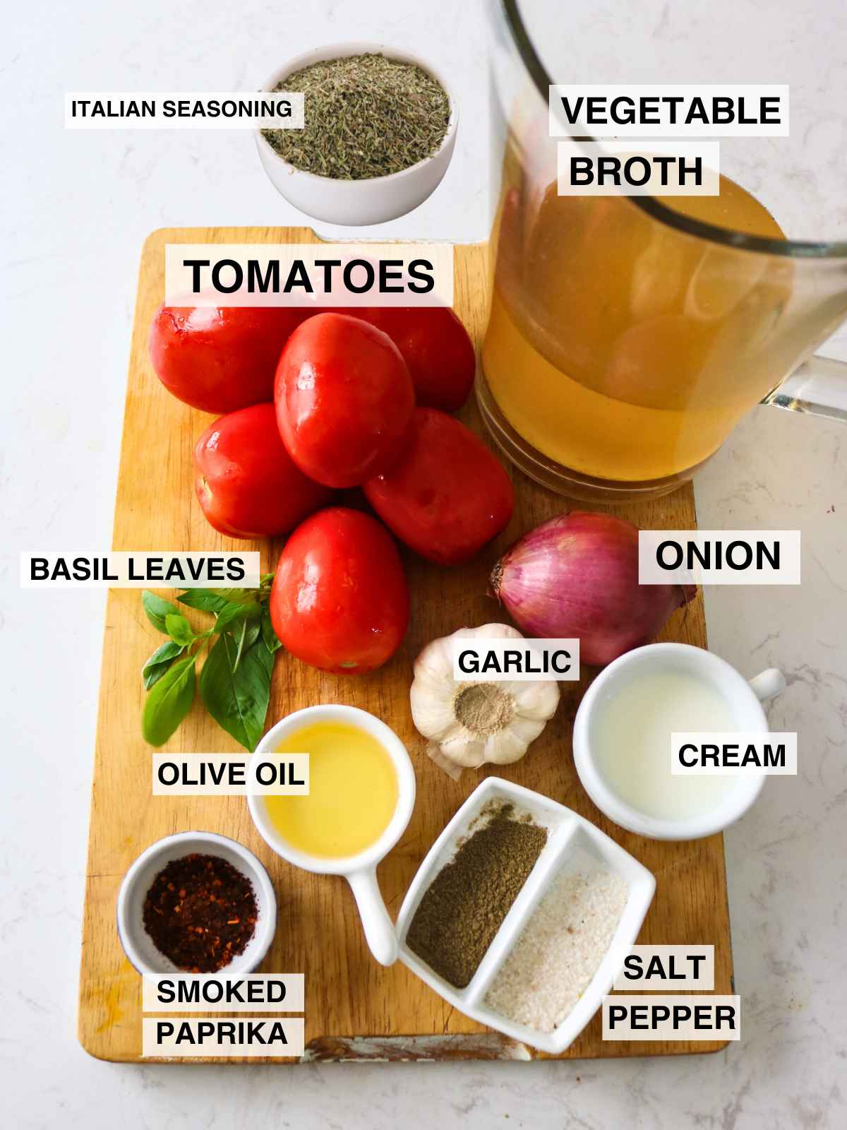 Ingredients with name tags to make roasted tomato garlic soup.