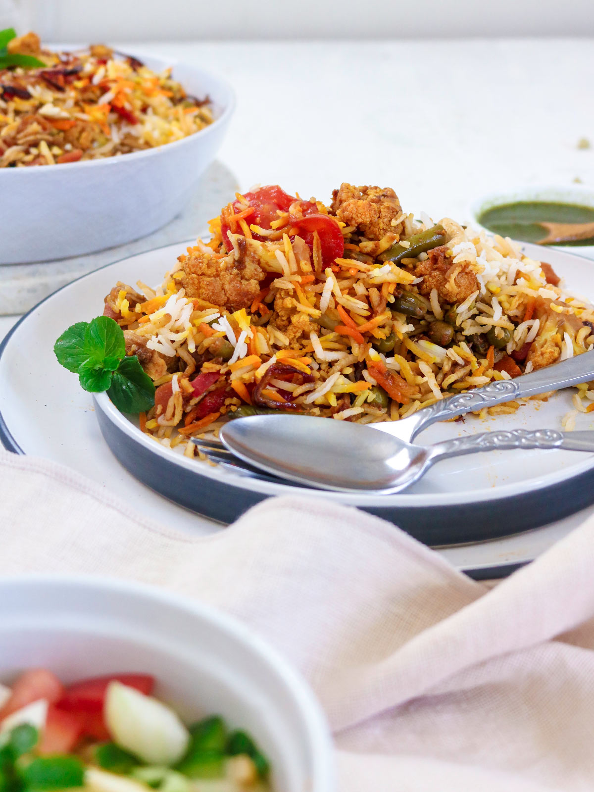 vegan Biryani served in a white plate.