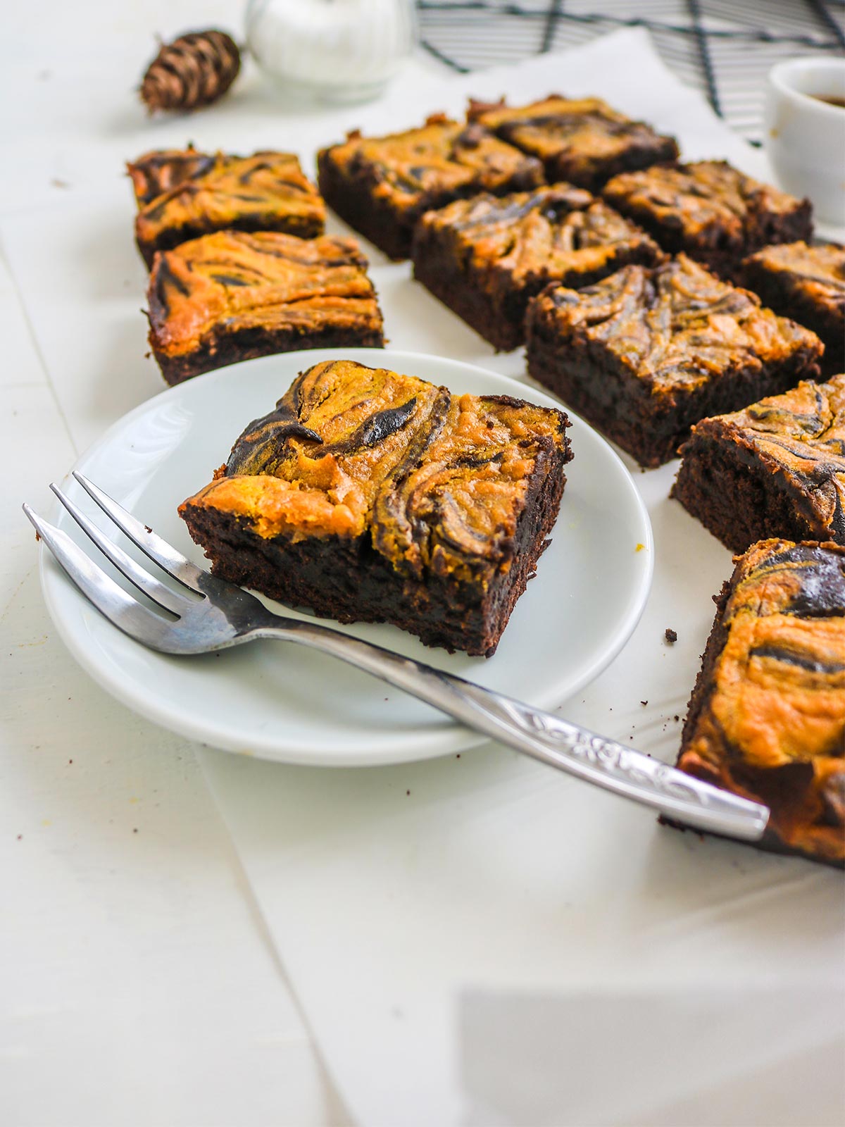 Pumpkin and chocolate brownies sliced and placed on a plate with a fork.