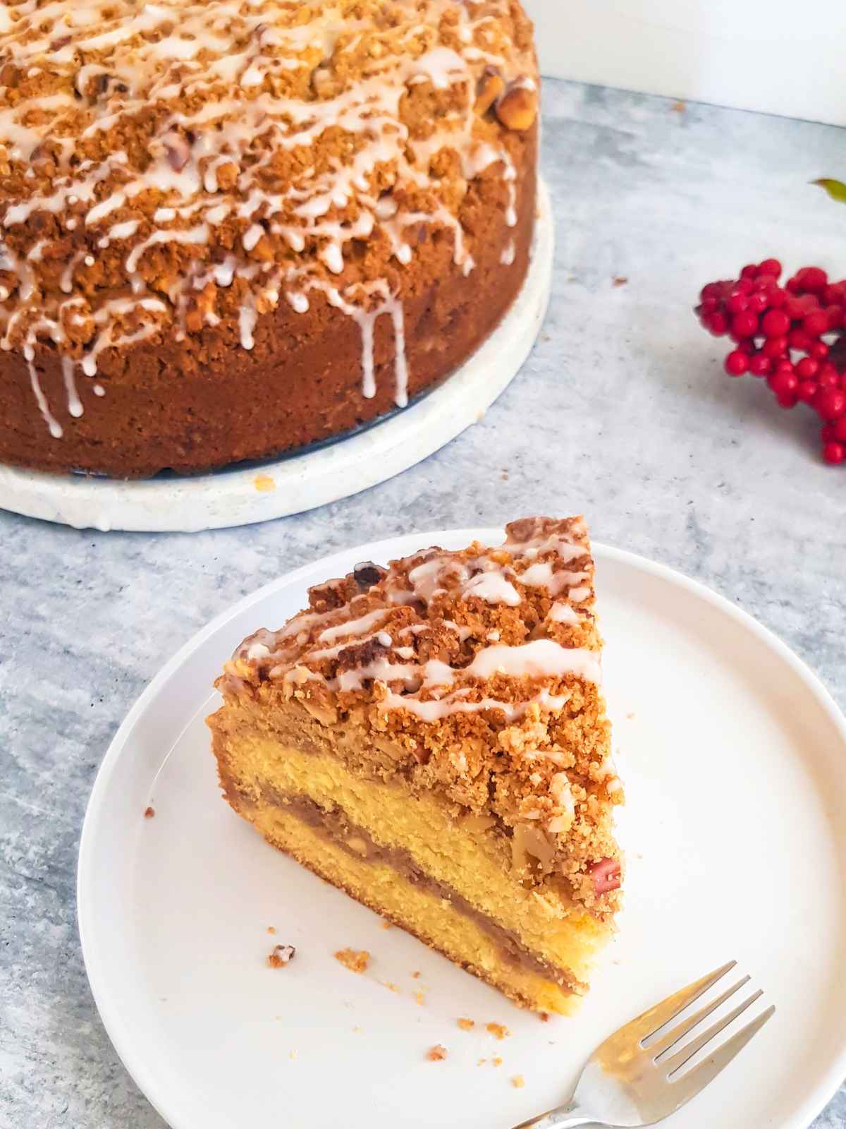 Coffe cake Slice placed on a white plate with a fork.